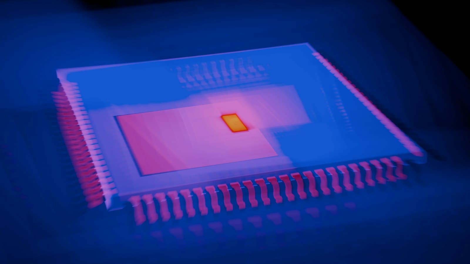 Close-up of a square microchip on a board, lit in blue and pink with a small glowing core at its centre